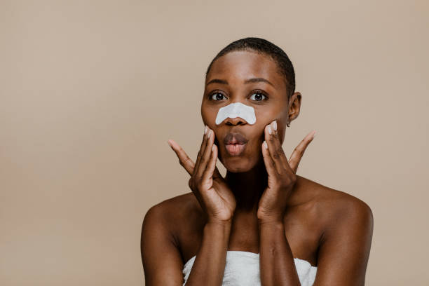 istock Black woman with a nose pore strip 2157060100