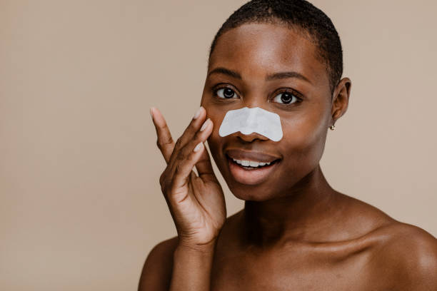 istock Black woman with a nose pore strip 2157060120