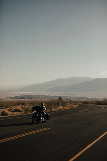 istock Man riding a motorcycle on a scenic route in USA 2157060602