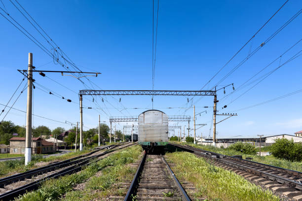 istock Rear view of a railway carriage standing on the tracks under a blue sky. 2157060962