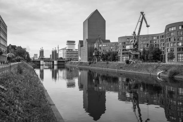 Duisburg, Germany - September 2, 2023: View of the Duisburg inner harbor district or Duisburg Marina  during nasty weather, North Rhine-Westphalia, Germany. Black and white photography.