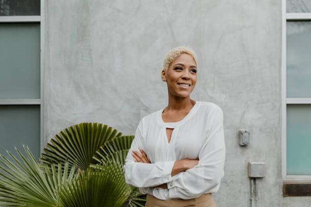 istock Black confident woman standing by the plant 2157061629