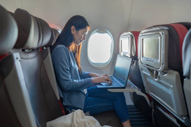 istock businesswoman works while in airplane 2157061986