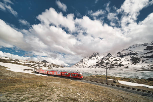 istock Red train in the Swiss Alps in the spring thaw 2157062028