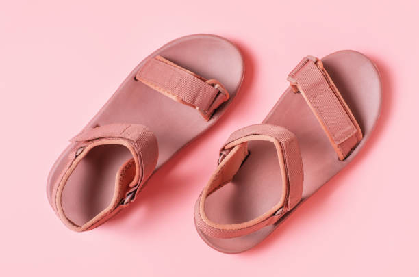 istock Female sandal on pink background close-up, top view. 2157062703