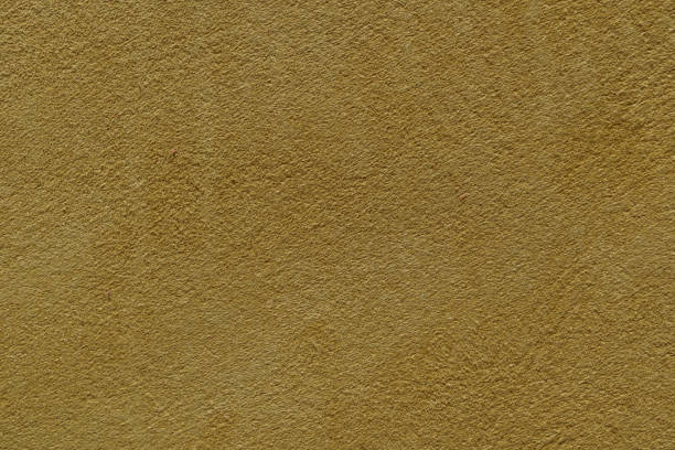 istock Mustard yellow wall with a subtle texture, a warm and inviting background perfect for design projects. 2157063032