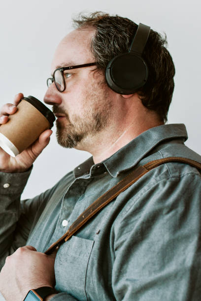 istock Man drinking a hot coffee while listening to music 2157063233