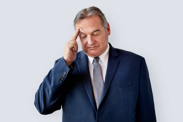 istock Stressed aged businessman touching his head 2157063241