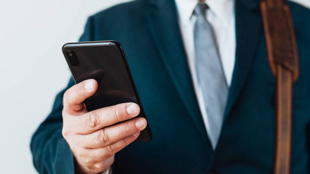 istock Closeup of a businessman using his phone 2157063255