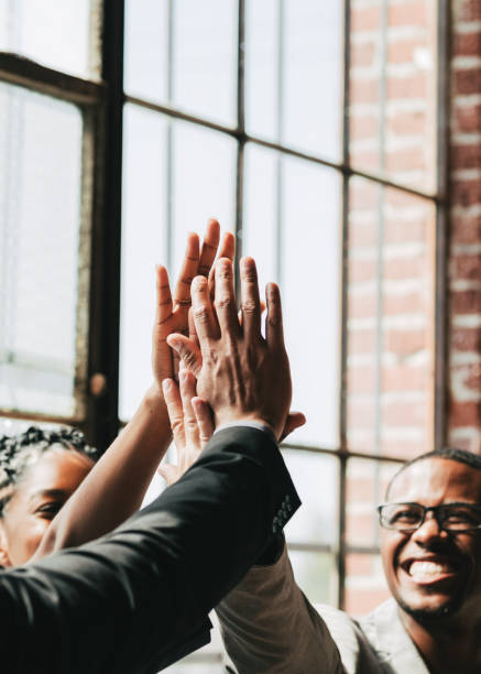istock Diverse business people giving a high five in the middle 2157064003