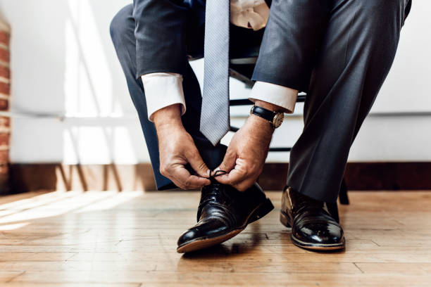 istock Businessman tying shoe lace before go to work 2157064344