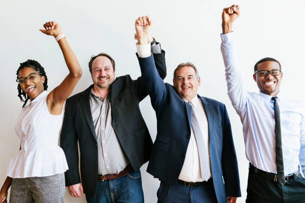 istock Diverse business team raising hands up in the air 2157064399