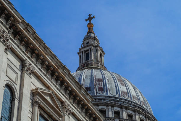 istock Dome structure with a cross on top attached to a grand cathedral with windows 2157065219