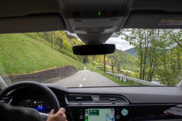 istock View of a rural road amidst forests from a passenger's backseat 2157065485