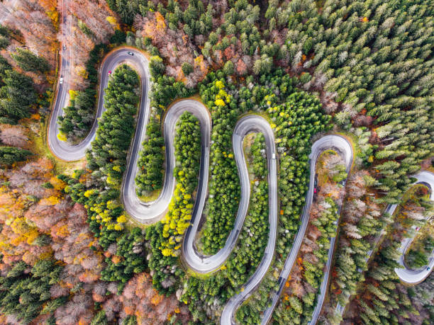 istock Curvy rural road in fall forest with spiral curve 2157065649