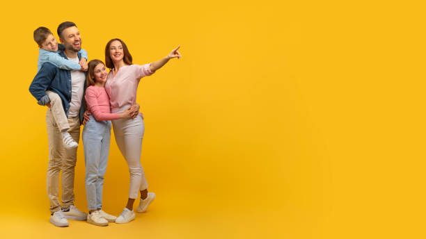 istock Happy family posing with yellow background, copy space 2157066192
