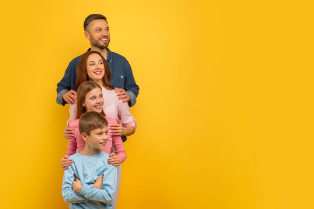 istock Family together with a cheerful expression on yellow background 2157066203