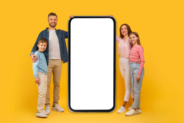 istock Family with large smartphone mockup on yellow background 2157066246