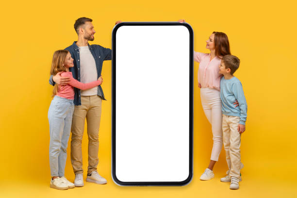 istock Family looking at big smartphone screen on yellow background 2157066256