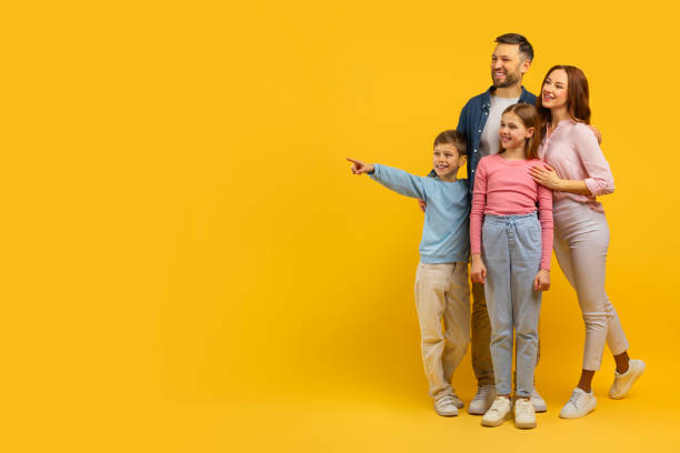 istock Family with two kids pointing and smiling 2157066273