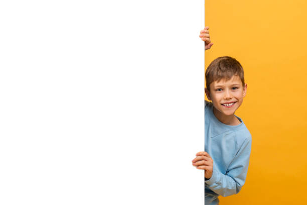 istock Young Boy Holding White Sign For Advertisement 2157066406
