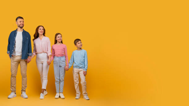 istock Smiling Family of Four Looking at Copy Space for Ad 2157066409