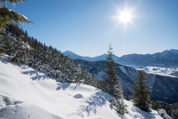 istock Sun shining behind snowy mountains in background 2157066442
