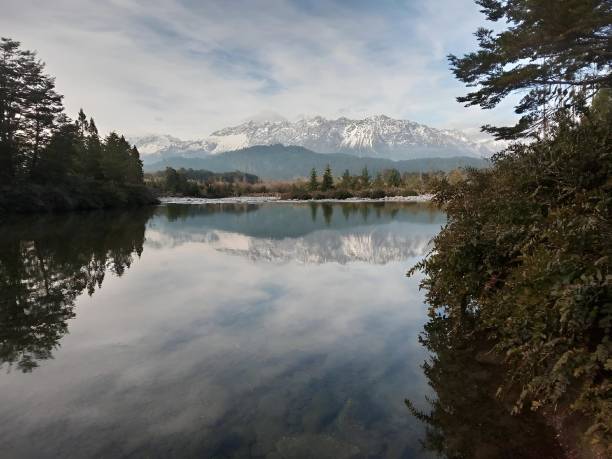 istock Scenic view of lake shore with distant mountains 2157066552