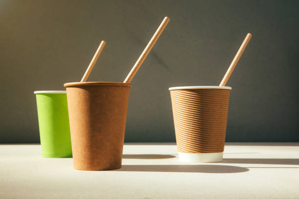 istock Paper cups  with paper straws on a brown cardboard background. Eco friendly, zero waste concept 2157067432