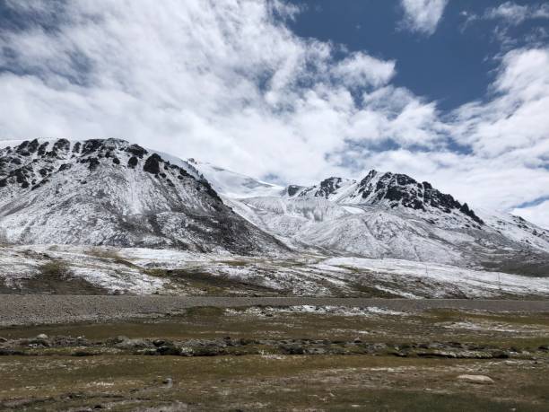 istock Scenic mountain range with snow and grass in the foreground 2157067533