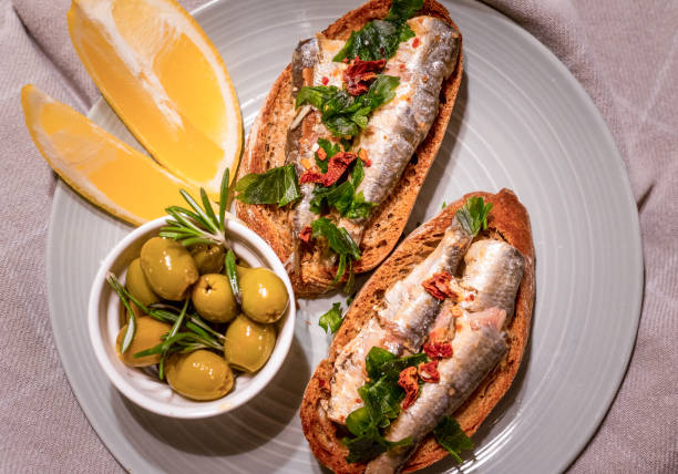istock there is a sandwich and an olives with sauce on a plate 2157067649