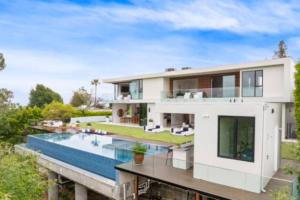 istock Sprawling house with a pool and potted plants perched on a verdant hilltop 2157067684