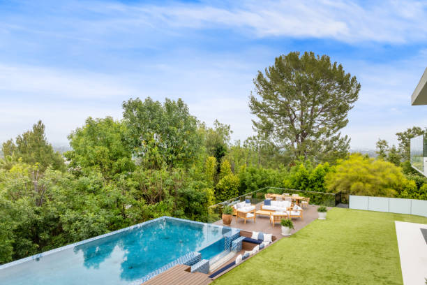 istock a large swimming pool surrounded by green grass and a deck 2157067695