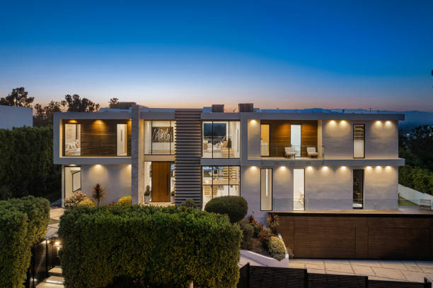istock Spacious white concrete house surrounded by lush green shrubbery 2157067784