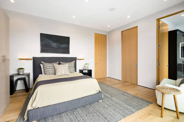 istock Spacious bedroom with hardwood floors and walls 2157067821