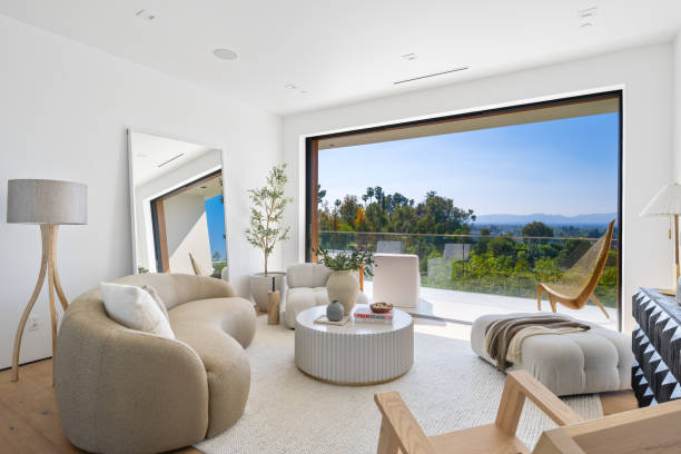 istock Spacious living room with forest view through a glass door 2157067967
