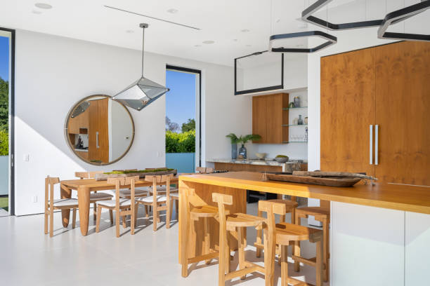 istock Wooden kitchen with a round mirror and windows looking at trees 2157068015