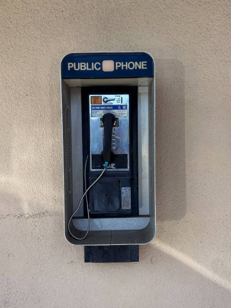 istock public phone with cord and phone on it on outside wall 2157068057
