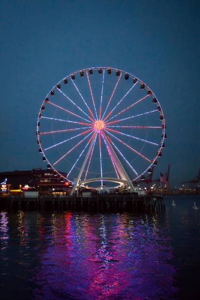 istock ferris wheel and a ferris wheel in a harbor at night 2157068187