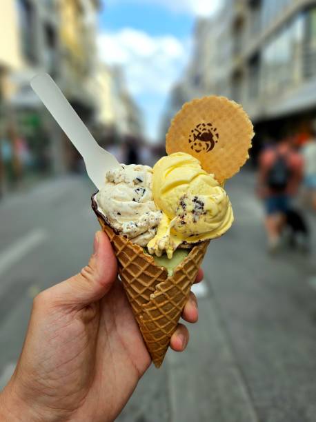 istock a person holding up an ice cream cone with two scoops 2157069244