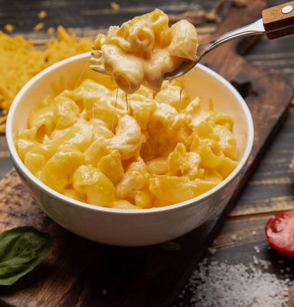 istock Wooden table with a bowl of mac and cheese 2157069426