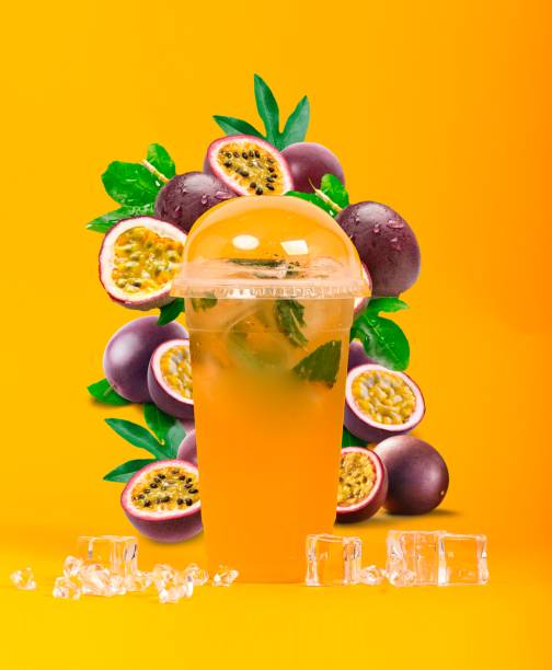 Glass of beverage beside assorted fruits