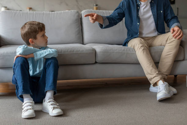 istock Father pointing finger at son in disagreement 2157069530
