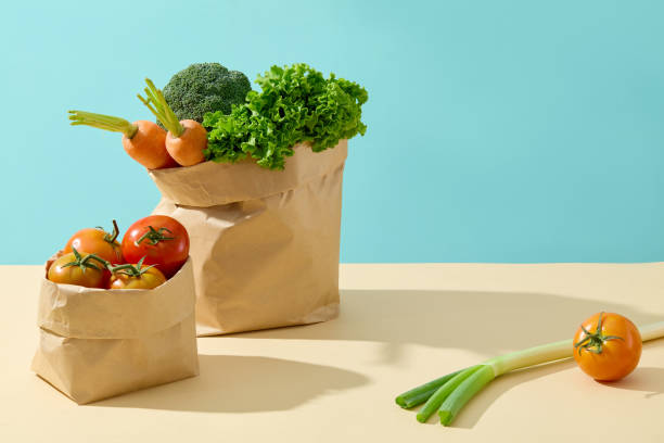istock The preparation for cooking meal with some fresh vegetables have just bought, still placed in paper bag consist of tomato, leek, salad, carrot and cauliflower. Blank space for product presentation 2157071406