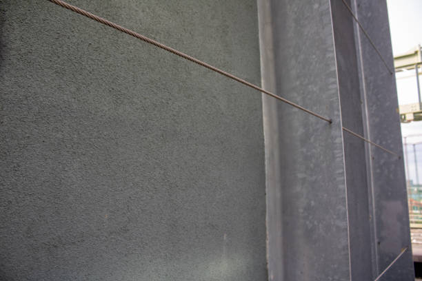 istock Green door handle mounted on wall next to a brown rope 2157071510