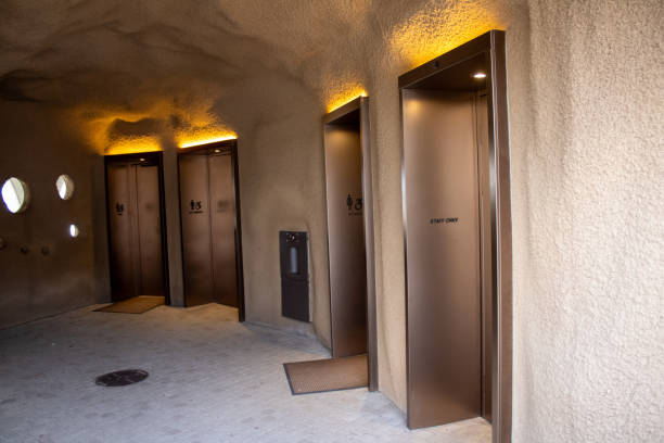 Elevators beside a stone wall with holes in them