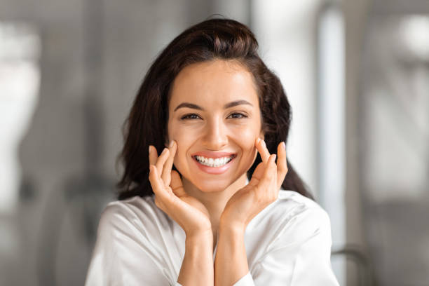 istock Beautiful long-haired brunette young woman touching her face 2157073158