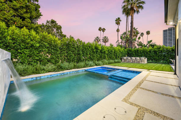 Backyard pool surrounded by lush greenery. California, USA