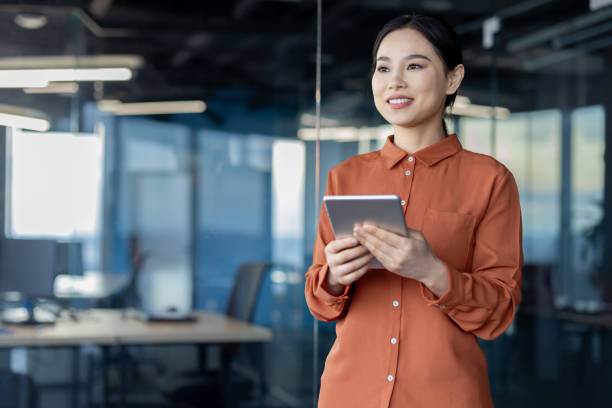 istock Confident Asian businesswoman using digital tablet in modern office 2157075309