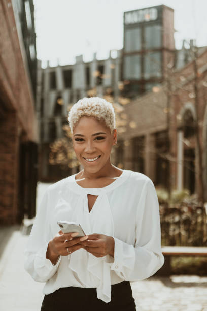 istock Happy black woman using her smartphone 2157075952